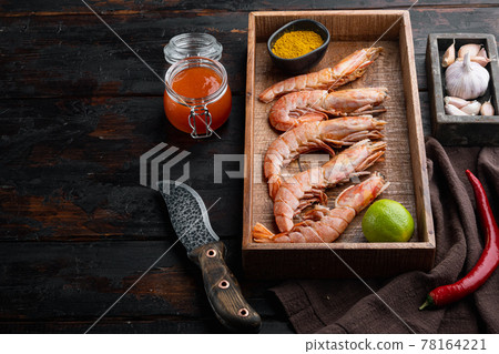 Large raw shell on raw king prawns, in wooden box, on old dark wooden table background , with copyspace and space for text Large raw shell on raw king prawns, in wooden box, on old dark wooden table background , with copyspace and space for text 78164221