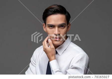 Portrait of smart handsome Asian man in corporate wear touching face  78165027