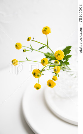 White home decoration with yellow flowers, ceramic vase and glass on tray White home decoration with yellow flowers, ceramic vase and glass on tray 78165508