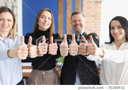 Smiling business people show thumbs up gesture stand in office Smiling business people show thumbs up gesture stand in office 78166432
