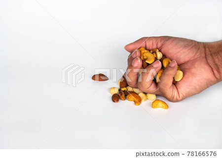 Concept, trail mix day. handful men trail mix on white background. closeup. copy space on left for design or text. Concept, trail mix day. handful men trail mix on white background. closeup. copy space on left for design or text. 78166576