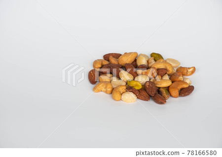 Concept, trail mix day. trail mix placed on a white floor table. Closeup. copy space on left for design or text. White background. Concept, trail mix day. trail mix placed on a white floor table. Closeup. copy space on left for design or text. White background. 78166580