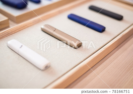 Case for an electronic cigarette on a beautiful shelf for sale. New technologies in tobacco products. Case for an electronic cigarette on a beautiful shelf for sale. New technologies in tobacco products. 78166751