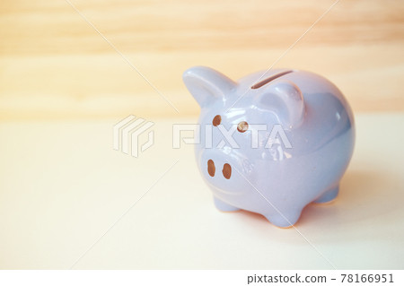 Close up of piggy bank standing on wooden background with copy space. Tonet. 78166951