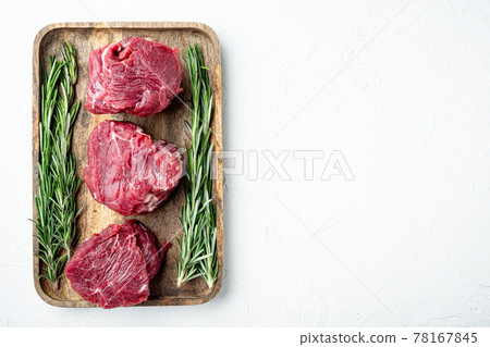 Tenderloin fillet mignon whole cut, on white stone background, top view flat lay, with copy space for text Tenderloin fillet mignon whole cut, on white stone background, top view flat lay, with copy space for text 78167845