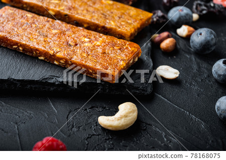 Healthy fitness energy bars with dried fruits with copy space,on black background Healthy fitness energy bars with dried fruits with copy space,on black background 78168075