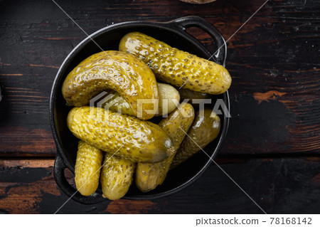 Pickled cucumbers, on old dark wooden table background, top view flat lay Pickled cucumbers, on old dark wooden table background, top view flat lay 78168142
