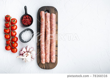 Traditional raw sausages, flat lay with space for text, on white background 78168316