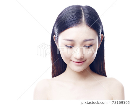 studio portrait of a young asian woman, looking down, isolated on white background 78169505