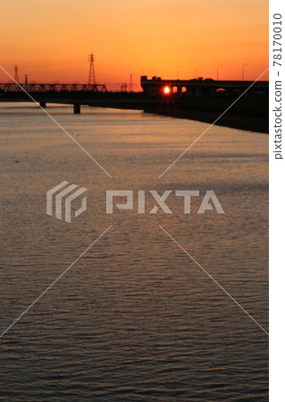 A fiery orange sky and river on the verge of sunset 78170010
