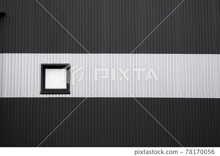 Black and white corrugated iron sheet used as a facade of a warehouse or factory with a window. Texture of a seamless corrugated zinc sheet metal aluminum facade. Architecture. Metal texture. 78170056