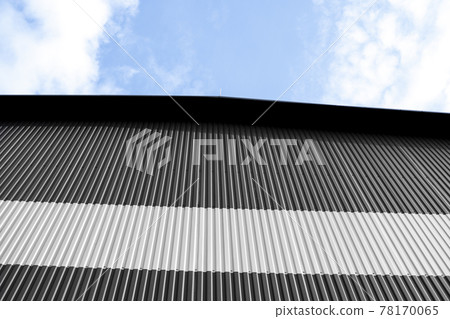 Black and white corrugated iron sheet used as a facade of a warehouse or factory. Texture of a seamless corrugated zinc sheet metal aluminum facade. Architecture. Metal texture. 78170065