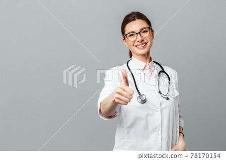 Portrait of a happy female doctor with a stethoscope showing the OK sign Portrait of a happy female doctor with a stethoscope showing the OK sign 78170154