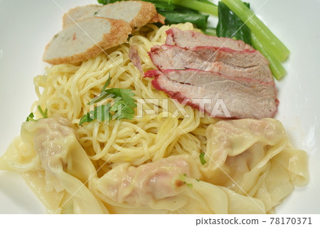 Chinese egg yellow noodles with barbecue pork and dumpling on plate with soup cup 78170371