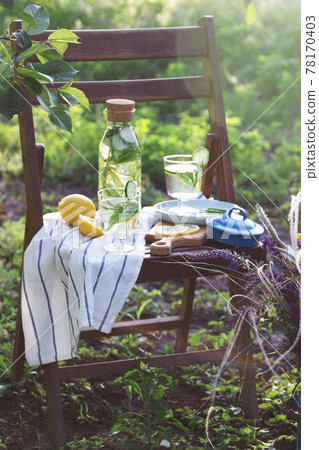lemonade on a vintage wooden chair in the garden 78170403