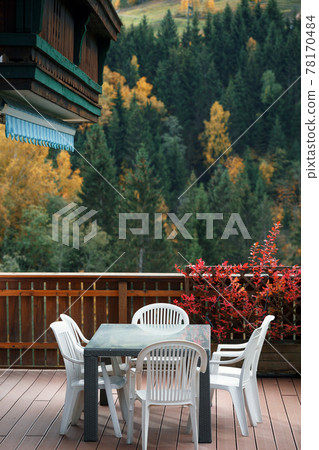 cozy terrace with a table and chairs cozy terrace with a table and chairs 78170484