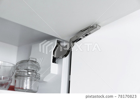 Kitchen cabinet with open fronts. Lift system for bifold fronts for direct access in kitchen cabinets.Innovative lifting mechanism for kitchen doors. Kitchen design. Kitchen cabinet with open fronts. Lift system for bifold fronts for direct access in kitchen cabinets.Innovative lifting mechanism for kitchen doors. Kitchen design. 78170823