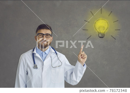 Portrait of proud doctor pointing at light bulb as symbol of innovative ideas and solutions Portrait of proud doctor pointing at light bulb as symbol of innovative ideas and solutions 78172348