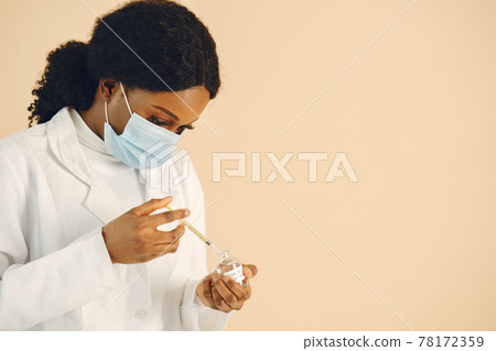 Medical worker taking vaccine solution with syringe Medical worker taking vaccine solution with syringe 78172359