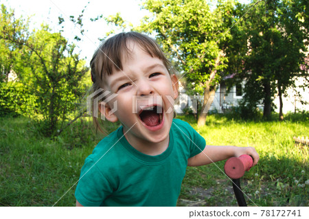 Portrait of a happy cheerful child outdoors Portrait of a happy cheerful child outdoors 78172741