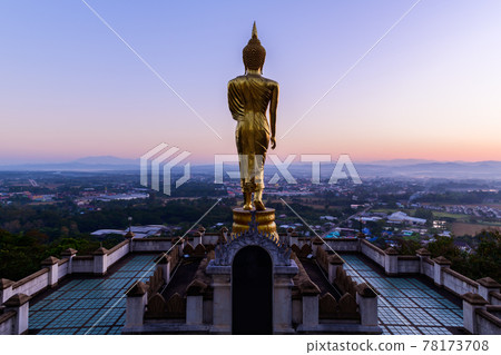 Big golden buddha statue standing in Wat Phra That Kao Noi 78173708