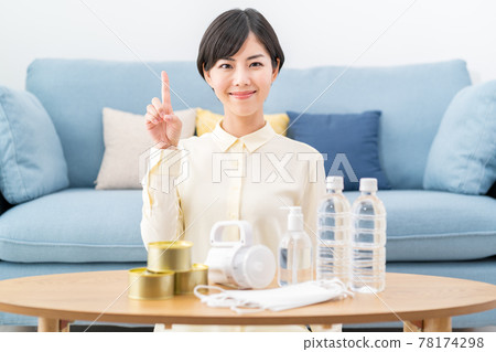 A woman checking the stockpile of disaster prevention supplies, evacuation supplies, and emergency food at home A woman checking the stockpile of disaster prevention supplies, evacuation supplies, and emergency food at home 78174298