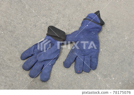 Fireman's gloves in firefighter's clothing after use. 78175076