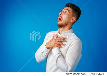 Amazed and confused bearded young man looks with astonishment. Amazed and confused bearded young man looks with astonishment. 78175621
