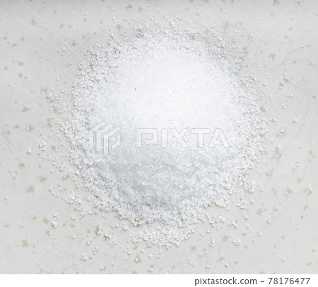 crystalline extract of stevia plant on gray plate 78176477