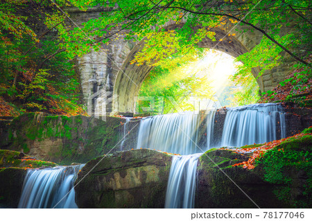 Waterfall landscape and sun - river waterfall in colorful mountain forest with old brige Waterfall landscape and sun - river waterfall in colorful mountain forest with old brige 78177046