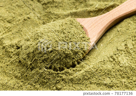 above view of wooden spoon with milled stevia herb 78177136