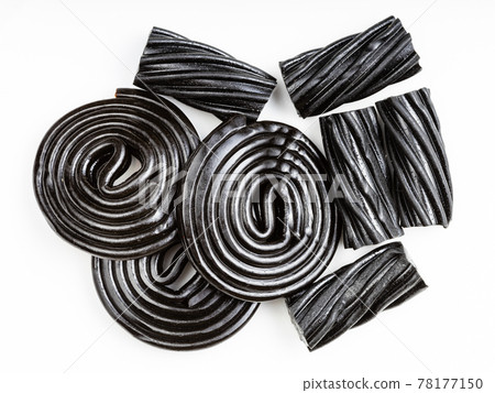 several black liquorice candies close up on white several black liquorice candies close up on white 78177150