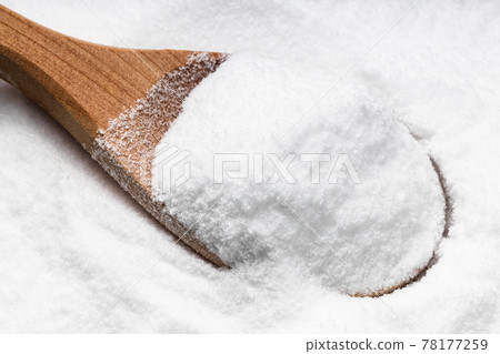 above view of wooden spoon with dextrose on pile 78177259