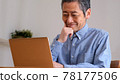 Senior man enjoying surfing the internet 78177506