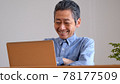 Senior man enjoying surfing the internet 78177509