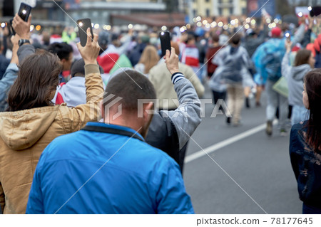 September 27, 2020 Minsk Many people, holding up their hands with flashlights on their mobile phones, walk down the street during the demonstration September 27, 2020 Minsk Many people, holding up their hands with flashlights on their mobile phones, walk down the street during the demonstration 78177645