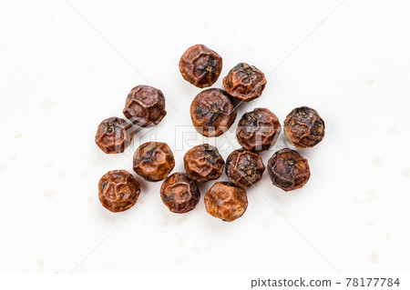 several red kampot peppercorns close up on gray several red kampot peppercorns close up on gray 78177784