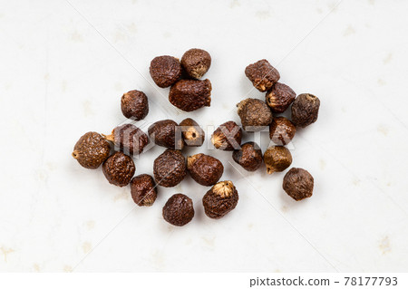 several grains of paradise pepper close up on gray several grains of paradise pepper close up on gray 78177793