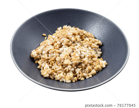cooked porridge from whole-grain oat in gray bowl cooked porridge from whole-grain oat in gray bowl 78177845