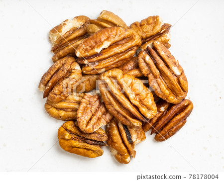 pile of shelled pecan nuts close up on gray pile of shelled pecan nuts close up on gray 78178004