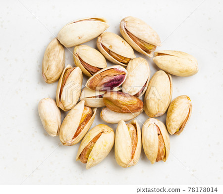 pile of shelled and ripe pistachio nuts close up 78178014