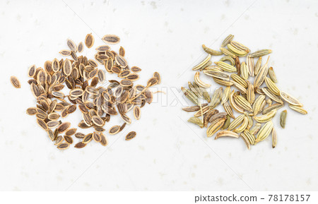 two pinches of dill and fennel seeds on gray 78178157