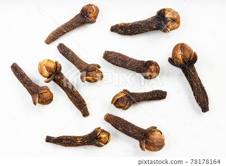 several whole dried cloves close up on gray several whole dried cloves close up on gray 78178164