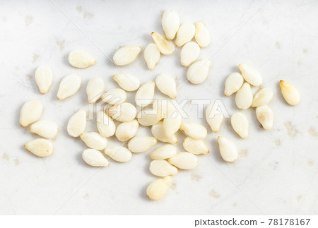 several white sesame seeds close up on gray several white sesame seeds close up on gray 78178167