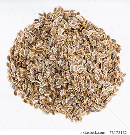 pile of dried dill seeds close up on gray 78178182
