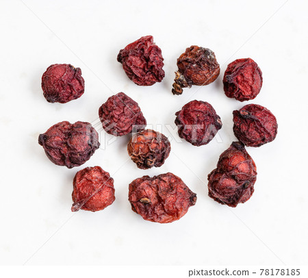few dried magnolia berries close up on gray 78178185