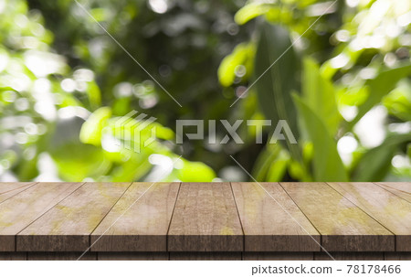 Empty wooden table top and green nature bokeh for display product. Empty wooden table top and green nature bokeh for display product. 78178466