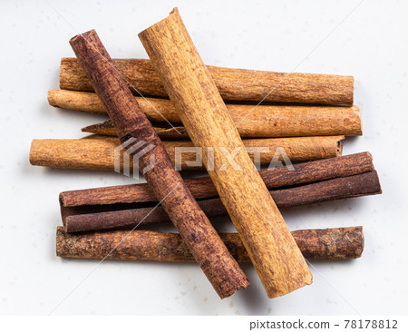 cassia (chinese cinnamon) quills close up on gray cassia (chinese cinnamon) quills close up on gray 78178812