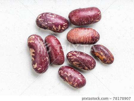 several red spotted pinto beans close up on gray 78178907