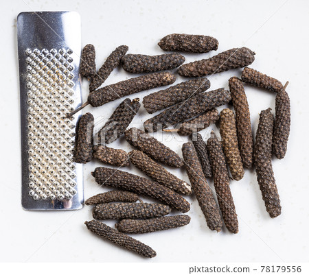 java long pepper with grater close up on gray java long pepper with grater close up on gray 78179556